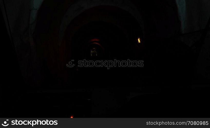 Driver operates a Funicular through a dark tunnel
