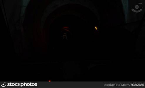 Driver operates a Funicular through a dark tunnel