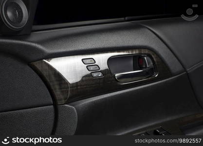 Driver seat memory button with two memory system for quick tilt adjustment and chrome door handle inside a luxury car