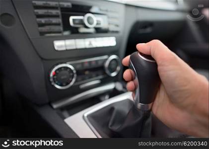 Driver shifting the gear stick in car