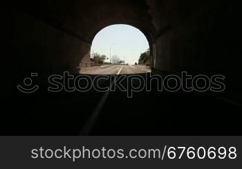 Driving car on coastal mountain road through the tunnel in direction of Yalta - Sevastopol