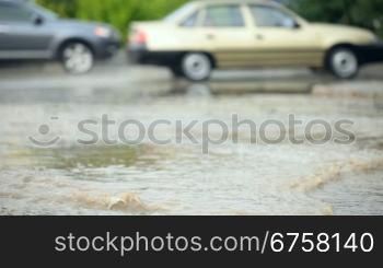 driving cars in bad condition after rain on a city road