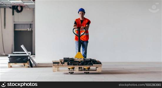 Driving construction material with hand pallet truck