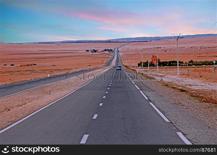 Driving through the Sahara Desert in Morocco Africa at sunset