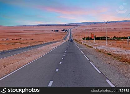 Driving through the Sahara Desert in Morocco Africa at sunset