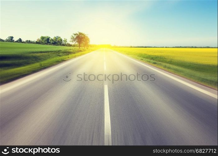 Driving to the sun. Beautiful yellow field countryside landscape