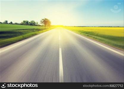 Driving to the sun. Beautiful yellow field countryside landscape