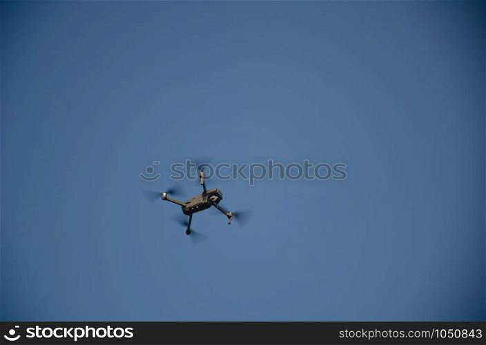 Drone copter with digital camera,Modern technology, UAV concept. Drone flying over blue sky day with digital camera