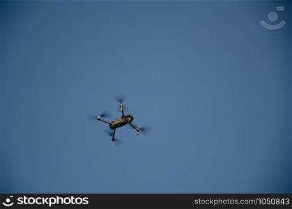 Drone copter with digital camera,Modern technology, UAV concept. Drone flying over blue sky day with digital camera