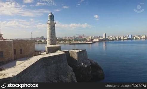 Drone flying over Havana, Cuba: Morro Castle and Malecon promenade. Aerial view of La Habana skyline, Cuban capital city. Urban landscape seen from the sky with old monument, landmark, Caribbean sea.