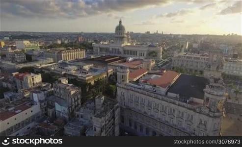 Drone flying over Old Havana, Cuba: Capitolio monument and Habana Vieja district. Aerial view of La Habana, Cuban capital city. Urban landscape from the sky with buildings, homes, houses, landmarks.