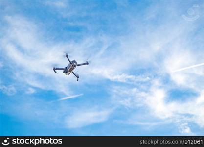 drone hovering in blue sky