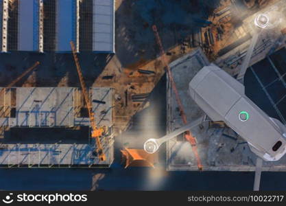 Drone over construction site. video surveillance or industrial inspection