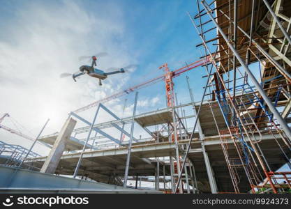 Drone over construction site. video surveillance or industrial inspection 