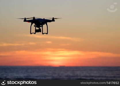 Drone quadcopter at sunset