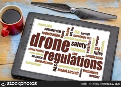 drone regulations (USA, FAA related) word cloud on a digital tablet with a cup of coffee
