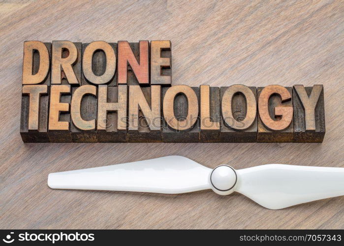 drone technology - word abstract in wood type. drone technology - word abstract in vintage lettepress wood type printing blocks with a propeller
