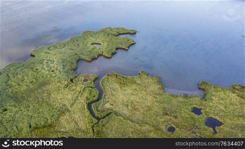 Drone top down bird&rsquo;s eye view landscape image of tidal wetlands in Christchurch Harbour on England&rsquo;s South Coast