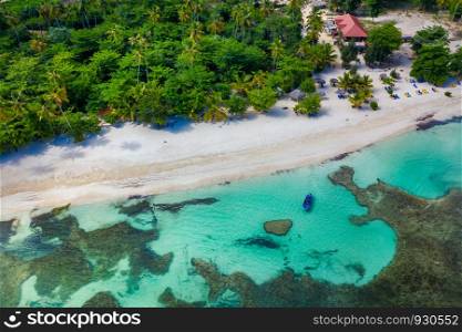Drone view of tropical beach with white boat anchored.Samana peninsula,Rincon beach,Dominican Republic.