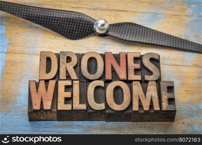 drones welcome word abstract in vintage letterpress wood type with a drone propeller