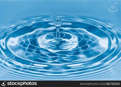 Drop in water. Blue waterdrop macro shot