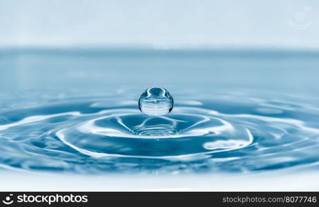 Drop in water. Blue waterdrop macro shot