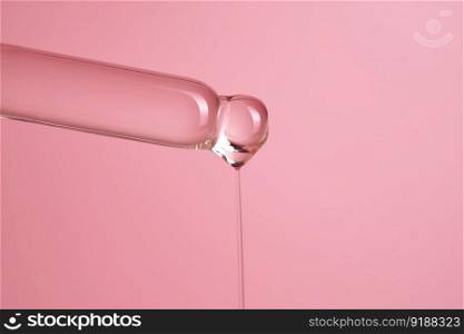 Dropper with serum or cosmetic oil on a pink background. A great photo for your business.. Dropper with serum or cosmetic oil on a pink background.