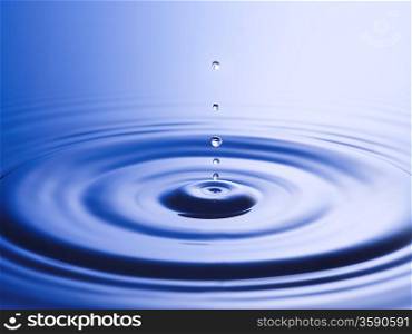 Drops hitting surface of water close-up
