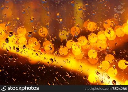 Drops of a rain on glass at night. Rain imaginations