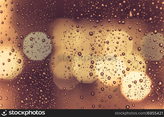 Drops of rain on window with abstract lights. Drops of rain on window with abstract night city lights