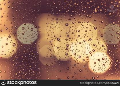 Drops of rain on window with abstract lights. Drops of rain on window with abstract night city lights