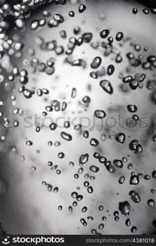 drops of water on glass with black boundaries macro shot