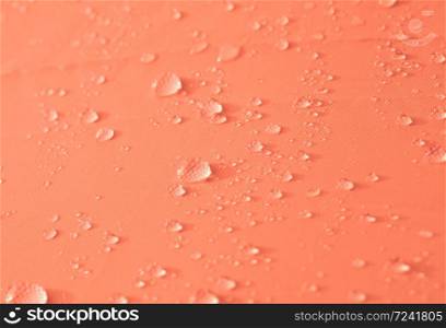 Drops of water or rain drop on orange background.