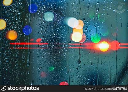 drops on the window and street lights background