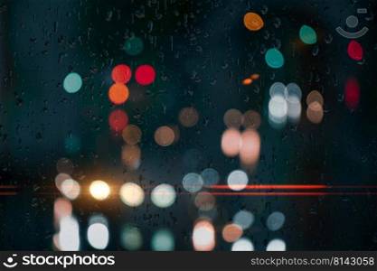 drops on the window with street lights background at night