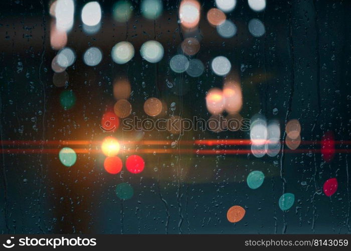 drops on the window with street lights background at night