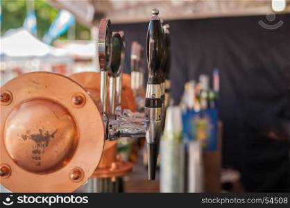 Drought beer taps and other beverages in a bar.