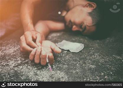Drug addiction, male using drugs in syringe