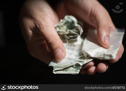 drug trafficking, crime, addiction and sale concept - close up of addict hands with drugs and money