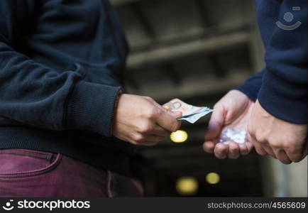 drug trafficking, crime, addiction and sale concept - close up of addict with money buying dose from dealer on street