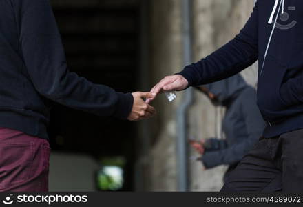 drug trafficking, crime, addiction and sale concept - close up of addict buying dose from dealer