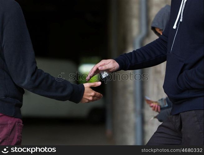 drug trafficking, crime, addiction and sale concept - close up of addict buying dose from dealer