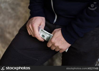 drug trafficking, crime, addiction, people and sale concept - close up of addict or dealer hands with dollar money and dose