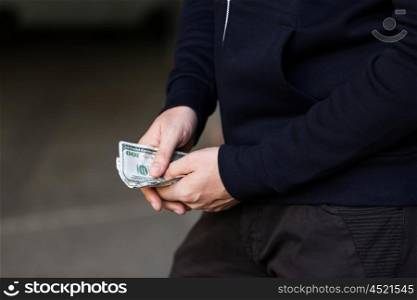 drug trafficking, finances, addiction, people and sale concept - close up of addict or dealer hands with dollar money