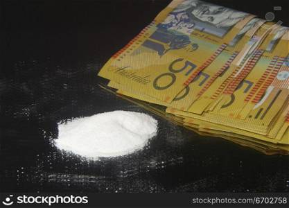 Drugs and money. cocaine, heroin, speed looking substance.