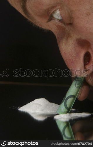 Drugs. cocaine, heroin, speed looking substance. Man Snorting drug with $100 Bill. Looking like a freak! .