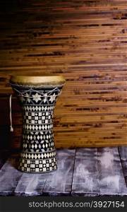 drum in the background Dark bamboo mat and wooden background