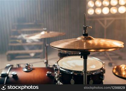 Drum-kit, drum-set, percussion instrument, drumkit on the stage with lights, nobody. Drummer professional equipment, beat set