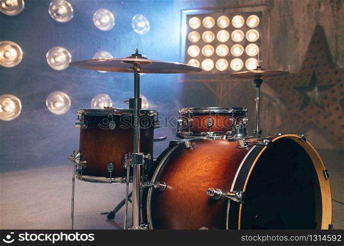 Drum-kit, drum-set, percussion instrument, drumkit on the stage with lights, nobody. Drummer professional equipment, beat set. Drum-kit, drum-set, percussion instrument, drumkit
