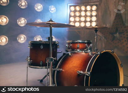 Drum-kit, drum-set, percussion instrument, drumkit on the stage with lights, nobody. Drummer professional equipment, beat set. Drum-kit, drum-set, percussion instrument, drumkit